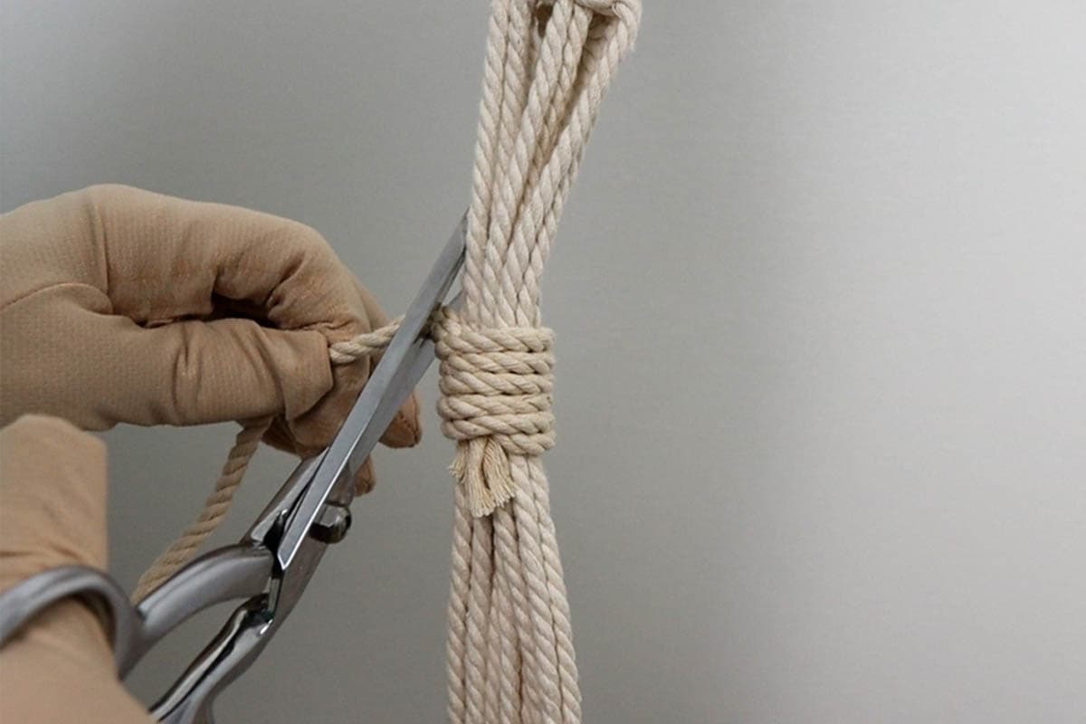 cutting excess cord from the wrapping knot