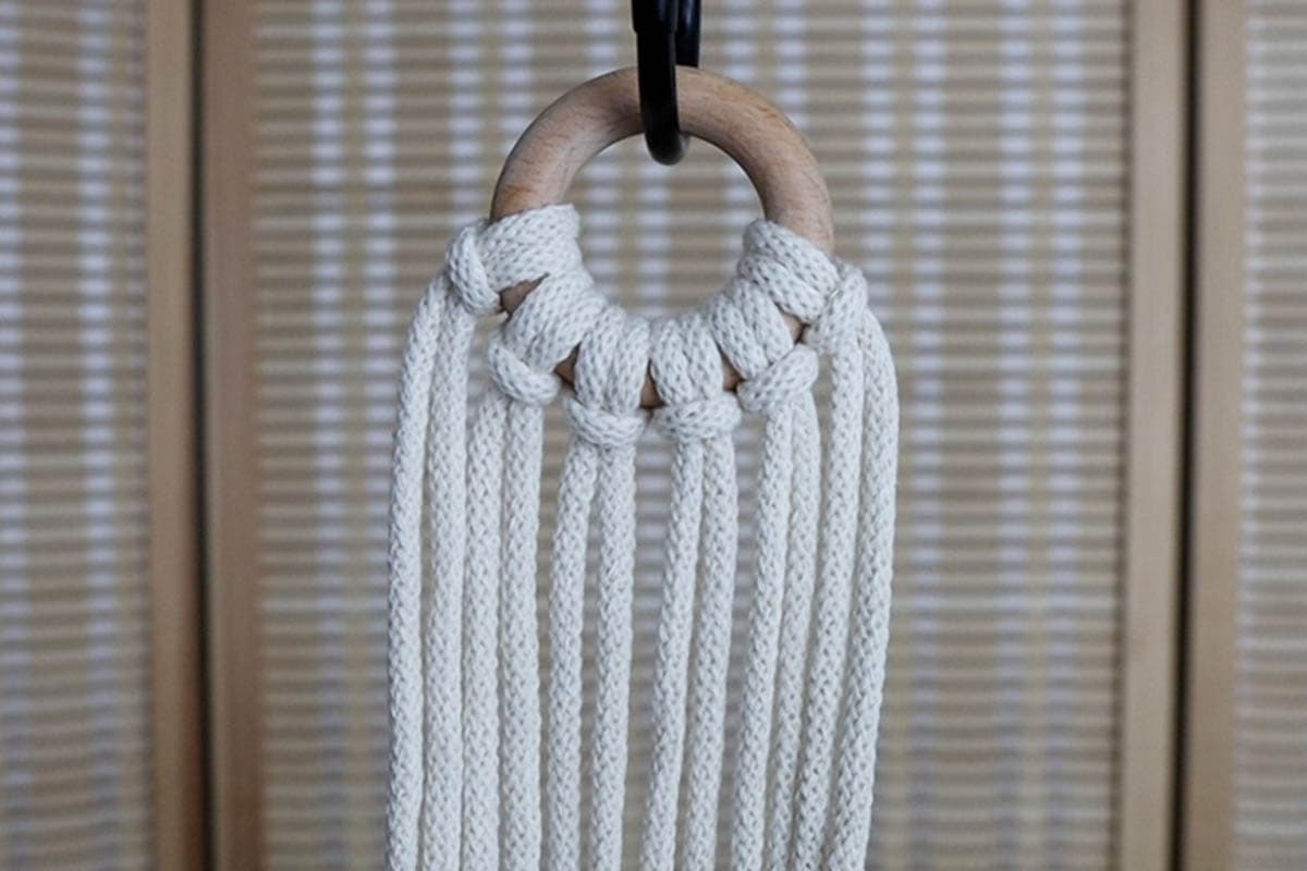 attach the cords to the ring with lark's head knots