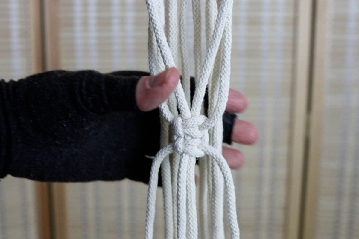 use those 4 cords to tie a stack of two square knots 5 inches down from the last row of knots