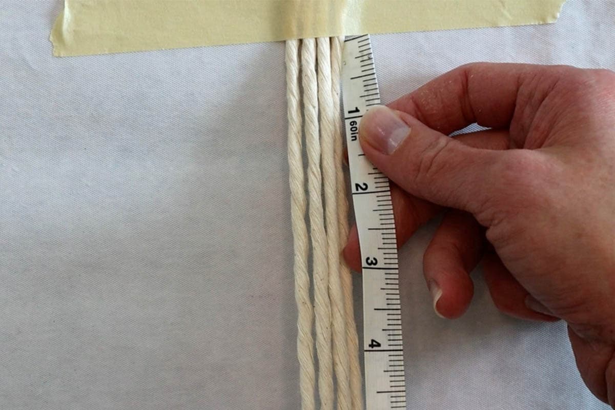 taping down the macrame cords