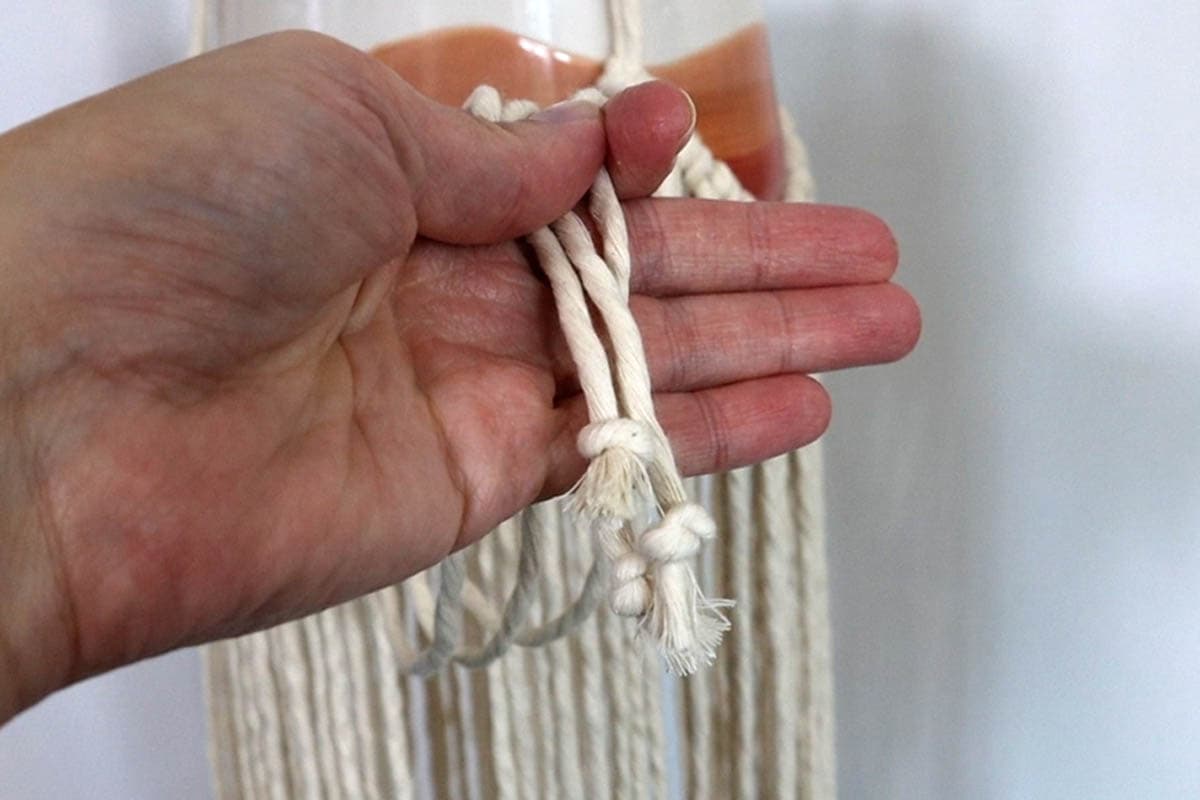 tyeing overhand knots in the bottom which is optional
