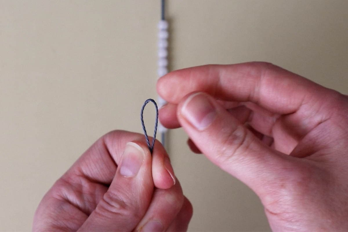 fold the working cord in half to find the center