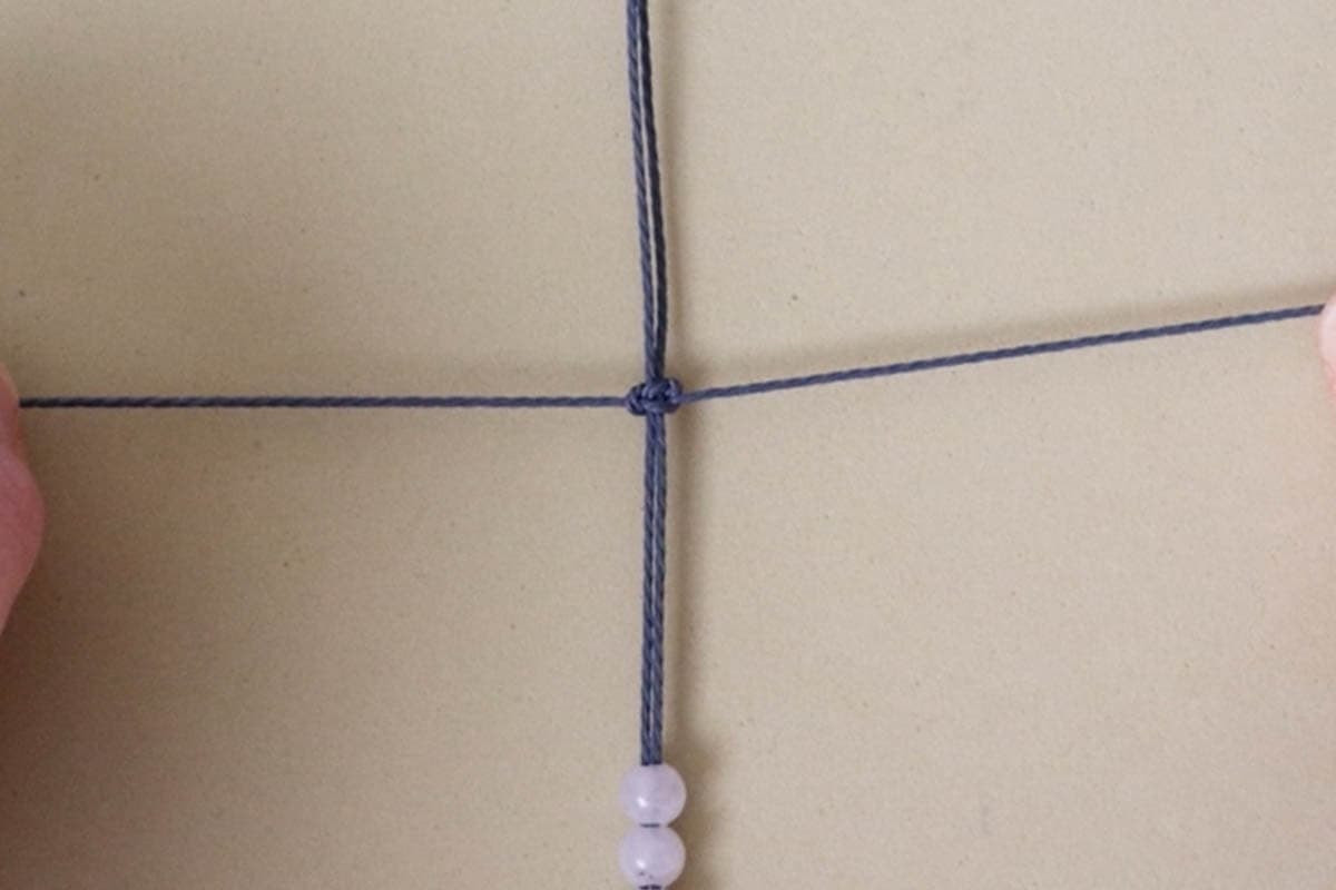 tying a square knot for beaded macrame bracelet
