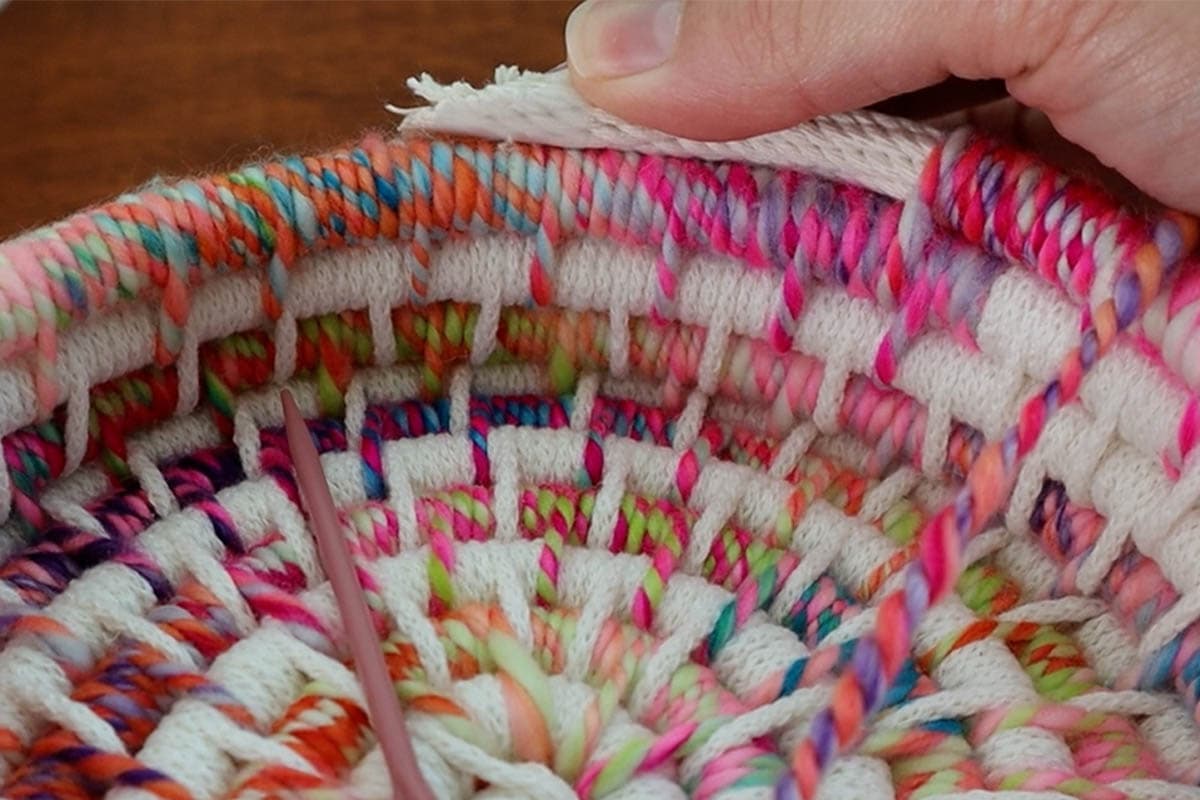 holding the cut filler cord in place to show how it will lay